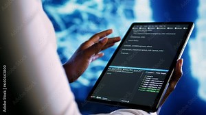 Adept technician programming scripts on tablet, employing AI machine learning. Meticulous employee manipulating lines of code for artificial intelligence applications development, close up