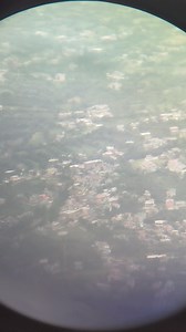 Trying to capture Bhuntar airport and surrounding view through binoculars from Bijli Mahadev Temple Kullu. | Manali