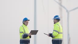 Engineer working in wind turbines farm.