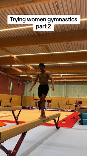 Male Gymnast Balances and Performs on the Beam