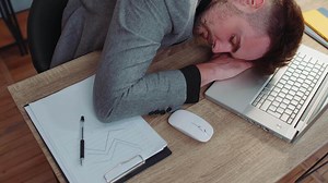 Bored tired sleepy business man falling asleep after routine work on laptop computer at office desk