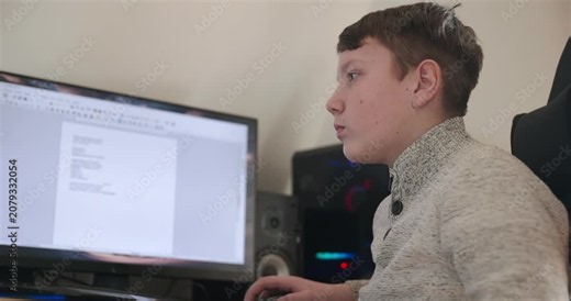 Kid Boy Use Desktop Computer for Study Typing and Reading. 4K 10-bit