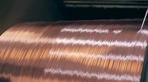 Rapidly-rotating spool with copper wire getting reeled onto it