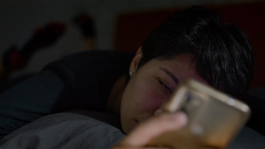 Face of a sleepy girl using her cell phone - Free Stock Video