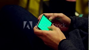 Sending text messages on cell phone, green screen