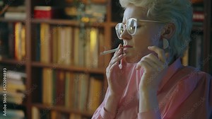 Middle-aged woman smoking cigarette, working in office, vintage atmosphere
