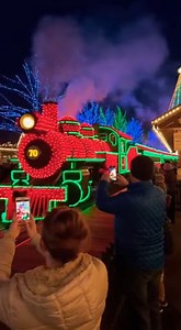 A magical clip was captured when Dollywood’s Christmas train lit up the park in full holiday spirit. The footage shows the Dollywood Express glowing red and green, rolling by as visitors enjoy the festive spectacle. Onlookers can be heard cheering and filming, with the train’s lights reflecting across the park. The clip quickly spread online, praised for capturing the enchanting holiday vibe that Dollywood is known for. *This is generated by AI for entertainment purposes.* #DollywoodExpress #Chr