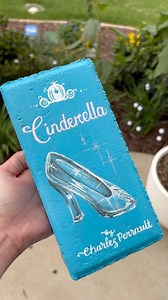 10M views · 299K reactions | Turning another brick paver into a book for my rainbow garden library. This time “Cinderella” by Charles Perrault. Supplies. Krylon Spray Paint#brickbook #brickpaverbook #brick-books #gardendiy | Melani Michelle Art | Facebook