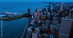 Lakefront of Chicago, Illinois, the USA at dusk. Numerous cars move by the highways at the waterfront. Top view.
