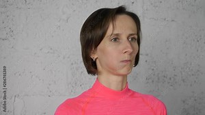 Young woman puffing out cheeks while face yoga on white background. Woman training facial gymnastics for lifting skin. Face skin care. Mimic gymnastic exercises Stock Video