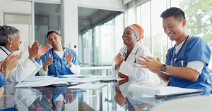 Medical staff, meeting and celebration of healthcare applause, happiness and positive energy for news of winning. Men and women or doctors and nurses hospital team clapping for a goal or achievement