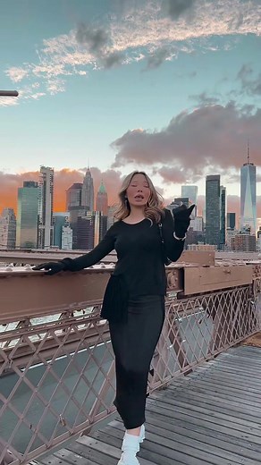 Cityscape Serenity: Woman on a Bridge at Sunset