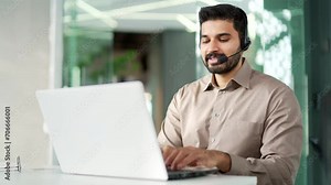 Corporate operator who works in customer support speaks on a video call using a laptop computer. Call center agent in wireless headset helping customer with complaints in office. Online consultation
