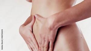 Female applying body lotion on her belly