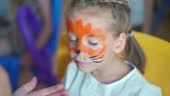 Children face painting. Artist painting with brash and special body...