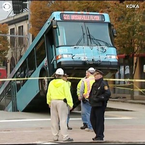 18K views · 235 reactions | A sinkhole swallowed the back half of a bus in downtown Pittsburgh during the Monday morning rush hour. The Port Authority said the bus was stopped at a light when the hole opened up. Officials said a driver and one passenger were on the bus and the passenger had minor injuries. Here's a look at the vehicle stuck in the middle of the street. | CBS LA | Facebook