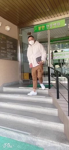 Person in White Hoodie Descending Outdoor Stairs