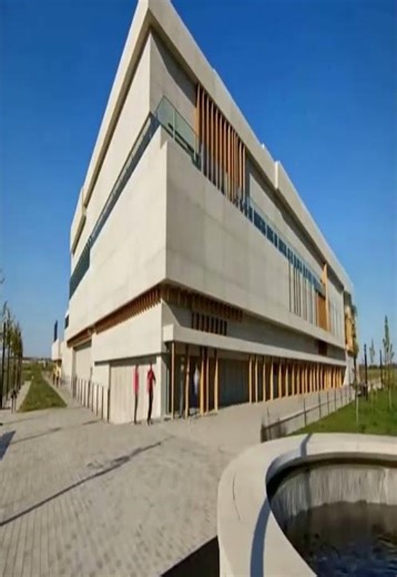 Minimalist Multi Story Building with Vertical Wood Accents