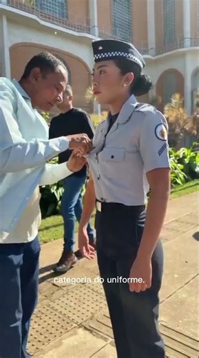Placement of insignia at a military graduation ceremony.