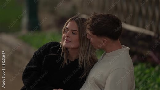 A young couple in Paris France shares an intimate moment The lovers embrace tenderly in an outdoor setting showcasing love and affection The clip is shot in slow motion emphasizing the romance and con