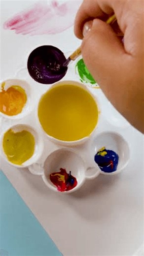 clip-4013464191-hand-uses-paintbrush-mix-deep-purple-watercolor