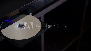Blu-ray Disc, Shot Eject From Blu-ray Disc Player. Unloading Compact Disc From The DVD/CD Player.