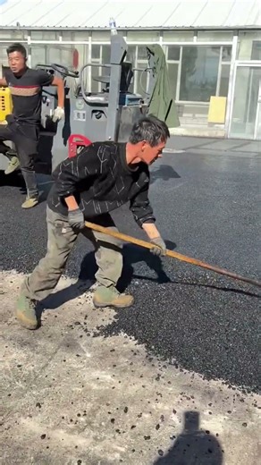 Applying and Compacting Asphalt to a Worn Cement Surface