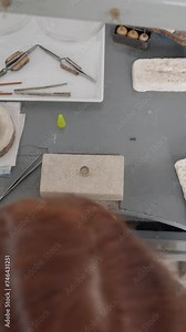 Female Jeweler Working At Workbench - Jeweler Creating Jewelry - overhead shot