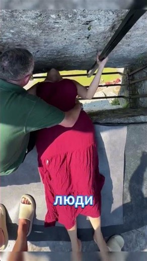 Why do people hang upside down to kiss the Blarney Stone?