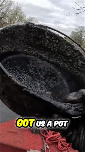 A river discovery: Someone pulls up a cast iron pot. The jokes fly as they imagine what it could cook up. A surprising find on the water. #RiverFinds #CastIron #TreasureHunt #RiverLife #MagnetFishing | The Fisher