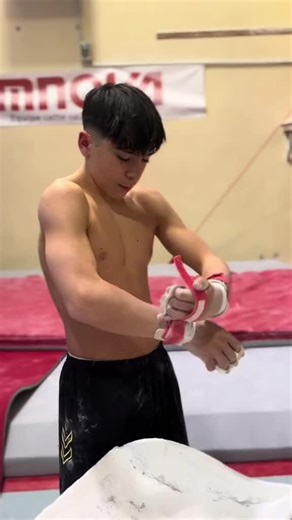 Young Male Gymnast Excels on Uneven Bars