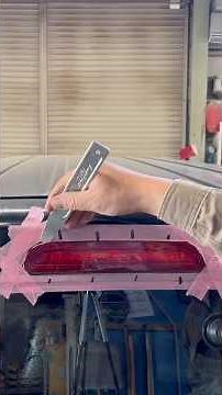 Removing the high-mounted stop lamp from a Hiace.
