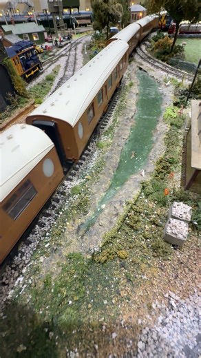 Thompson B1 61310 passes the stream pulling LNER teak carriages.