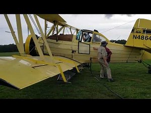 radial engine ag cat geting loaded with seed