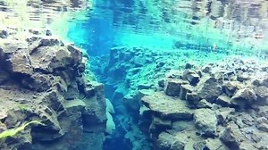 Wetsuit snorkeling between continents in Silfra Fissure, Iceland - Free Underwater Photos