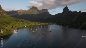 Yachts at anchor in a stunning bay in Moorea island in the South Pacific