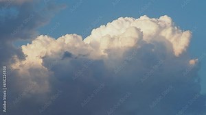 Beautiful yellow clouds in sky. Volumetric light effect. Sunrays are hidden behind approaching dark clouds. Cumulus convection in troposphere. Cumulonimbus vertical developed. Sunset and sunrays