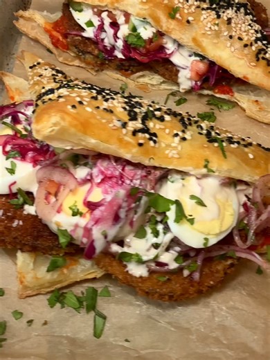 https://littleferrarokitchen.com/sabich-sandwich-with-fried-eggplant-and-tahini/ Sabich is a beloved Israeli sandwich layered with fried eggplant, hard-boiled eggs, fresh salads, and creamy tahini. Here, it's served in golden puff pastry for a fun twist. #comfortfood #easyrecipe #mediterranean #mediterraneanfood #dinnerideas #appetizers #budgetrecipe #mediterraneandiet #healthycooking #healthyrecipe #sabich