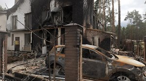 Burnt houses and cars as a result of artillery or rocket fire by the Russian army in the Kiev region
