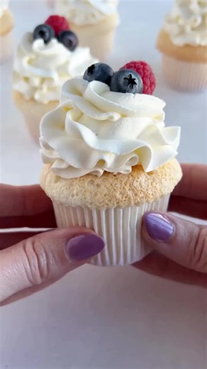 Looking for a sweet treat that is a little lighter this time of year? Look no further than my homemade angel food cupcakes with vanilla whipped cream! Comment RECIPE to have the recipe sent to your inbox or find it on cakemehometonight.com! #cupcake #cupcakes #angelfood #angelfoodcake