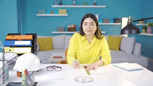 Architect young woman drawing a project. Architect young woman working from home drawing projects, thinking, finding ideas.