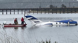Small airplane skids off runway into water in North Bend; 5 people rescued