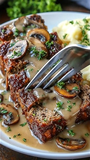 Classic Meatloaf with Mushroom Gravy This hearty and flavorful classic meatloaf is topped with a savory mushroom gravy that adds richness and depth to every bite. It's a timeless comfort food recipe your whole family will love! Ingredients: For the Meatloaf: 2 pounds (900g) ground beef (80/20 preferred) 1 cup breadcrumbs 1/2 cup milk 2 large eggs Full Recipe in Coʍmеոτ | The Cozy Plate