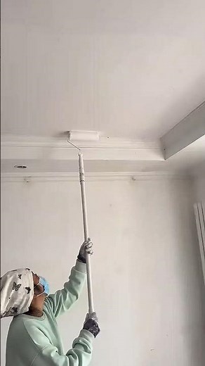 Ceiling Painting Technique: Rolling White Paint onto the Interior Surface