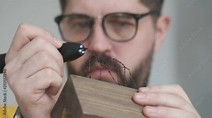 Male artist at work. Man designer creates 3d shapes for his collection. Design and art. Tools for 3d drawing. Hands close up.