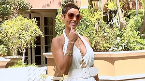 Nicole Murphy glows in a white summer dress at charity event