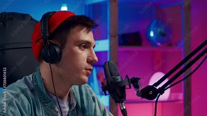 gamer guy blogging, commenting hard match, looking at computer monitor, using computer mouse and keyboard. Cybersport, gaming club. Young Handsome Pro Gamer live stream playing Online Video Game