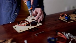 Robotic school project: Student building robot at artificial intelligence class - STEM education