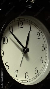 Vertical time lapse video of a clock time passing over a day to night on black background.
