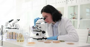 Long-haired worker detects presence of harmful bacteria using microscope and slams hands on table in anger slow motion. Technically advanced chemical laboratory